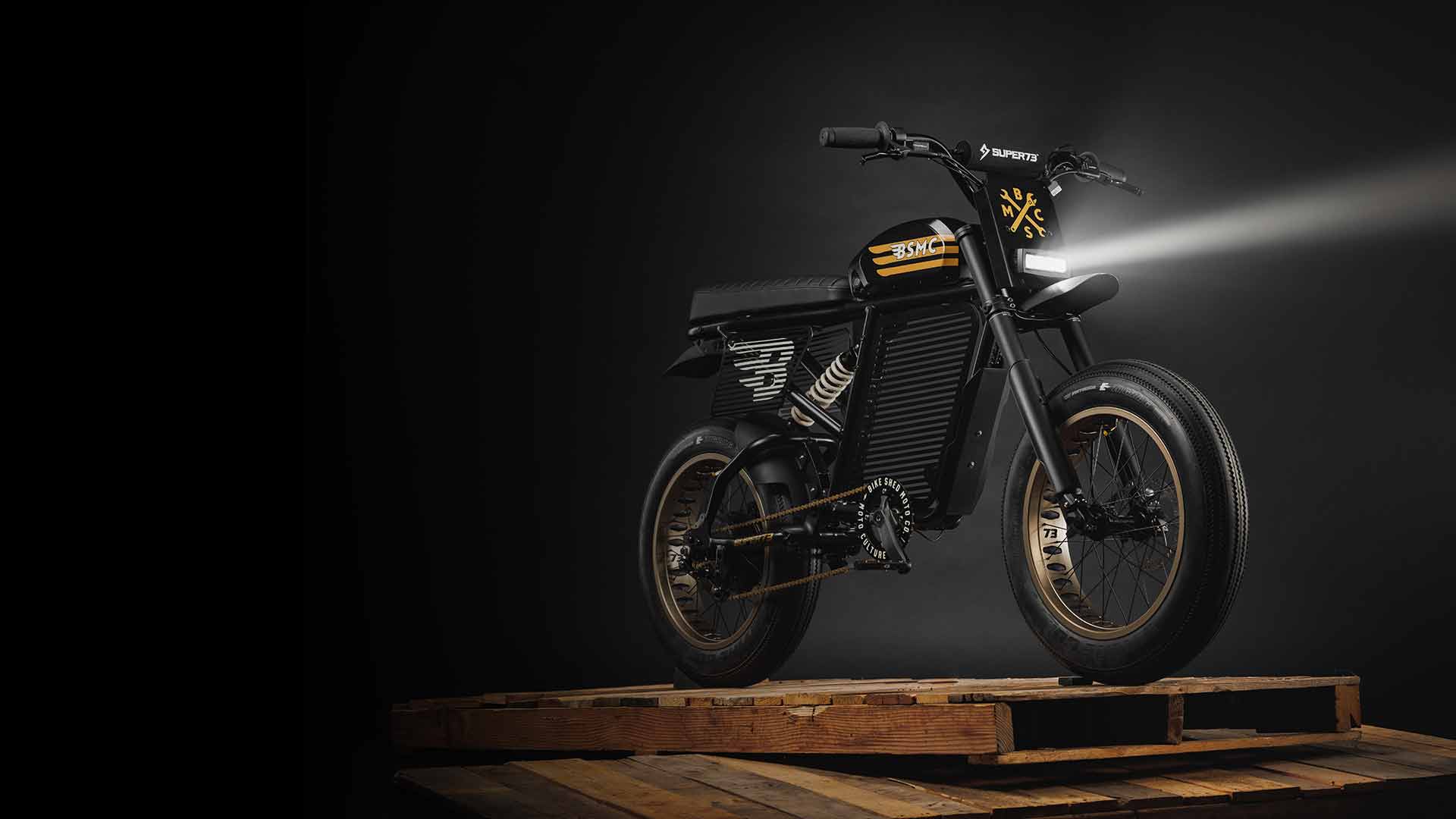 SUPER73 ebike Bike Shed Custom sitting on a pile of wood palettes
