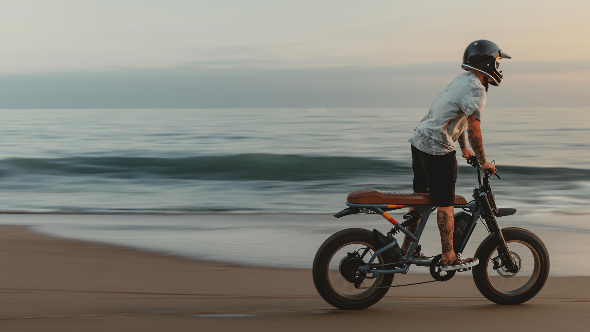 Man on a SUPER73 bike at the beach.