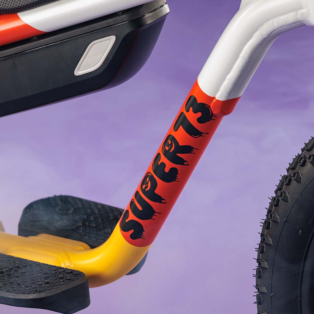 Closeup of the SUPER73-K1D Candy Corn Cruiser showing the paint detail.