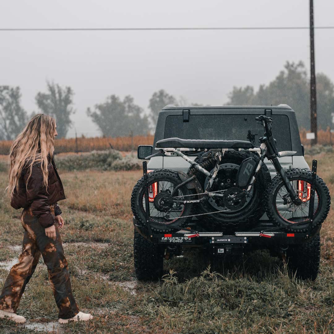 Lifestyle image of the 1UP USA x SUPER73 Bike Rack on the back of a Ford Bronco.