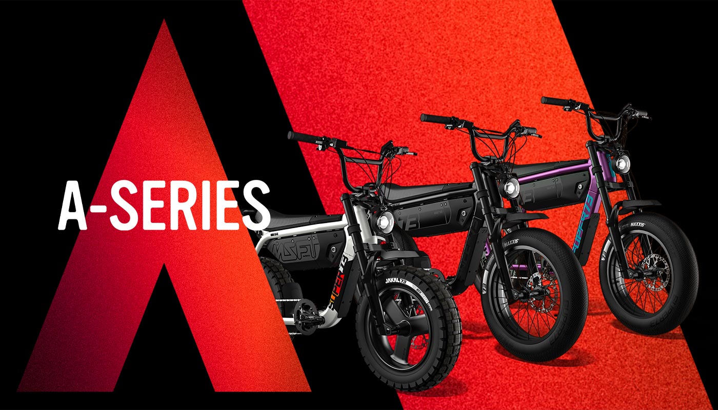 Three brand-new A-Series models lined up against a red and black background. From left to right: SUPER73-MZFT SE in Baja, SUPER73-M1D SE in Blackout, and SUPER73-B1G SE in Cullenberry.