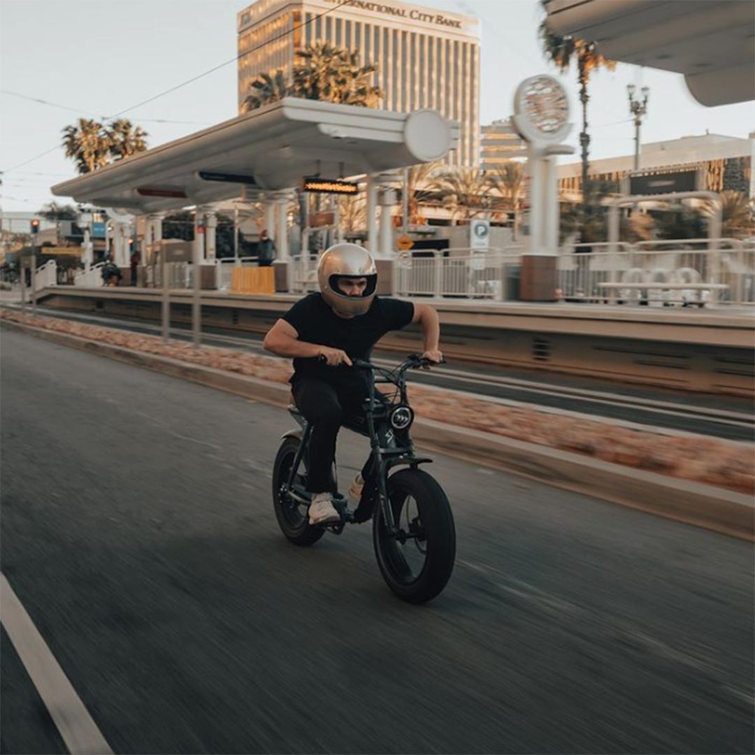Lifestyle image of a SUPER73 rider on his S2 riding through the downtown Long Beach