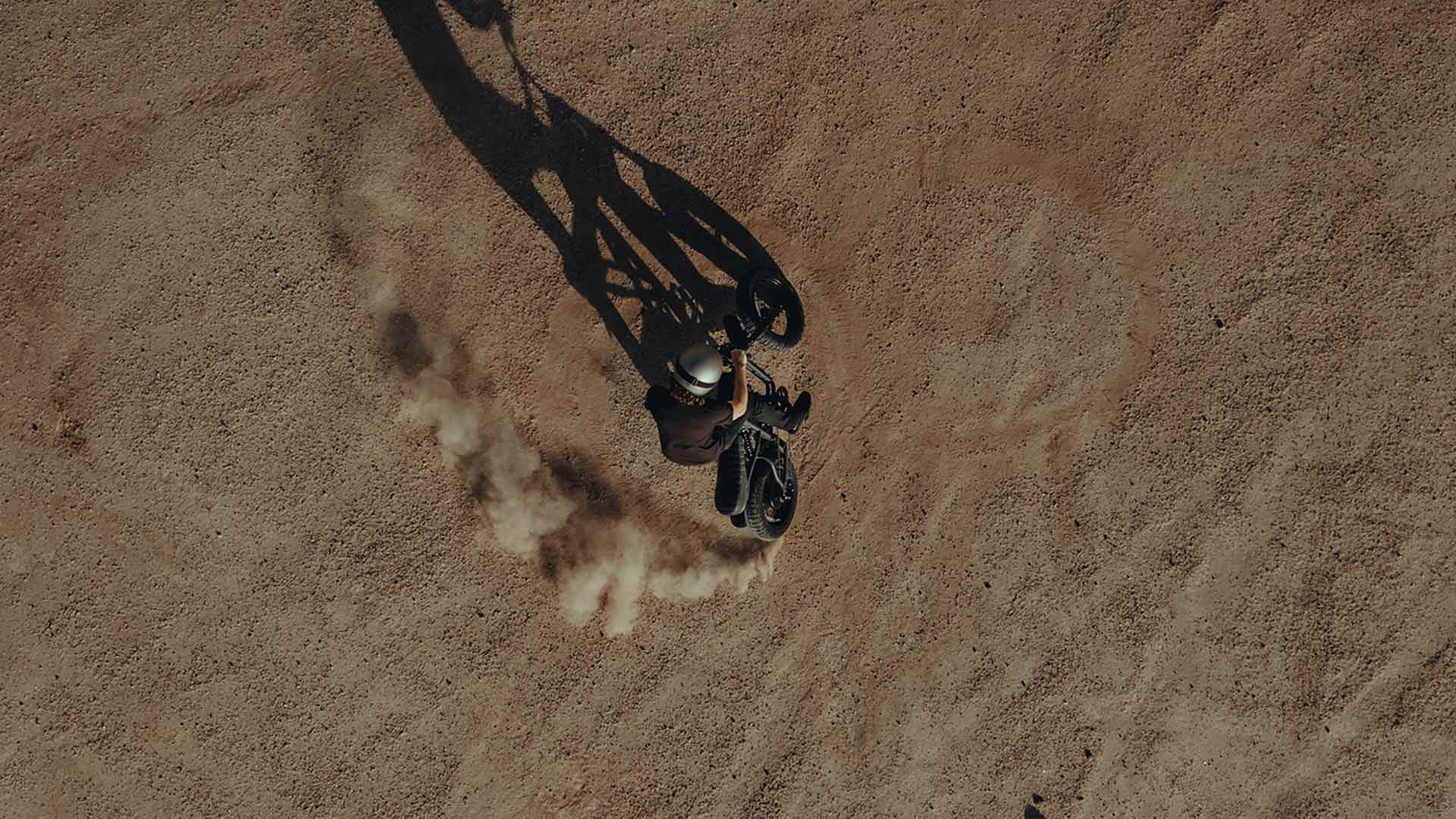 Rider on a Super73 ebike kicking up sand