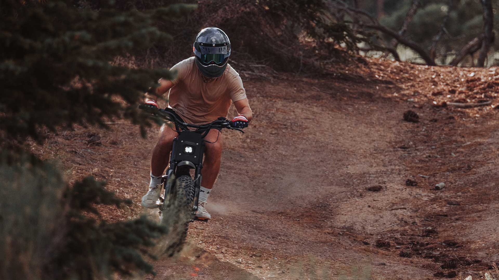 Rider on Super73 RX charging down a dirt path with a helmet