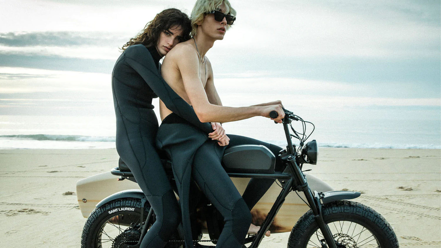 Two models riding super73 on a beach