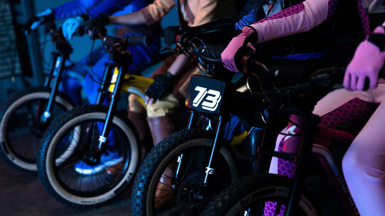 Youth series bikes lined up in futuristic lighting