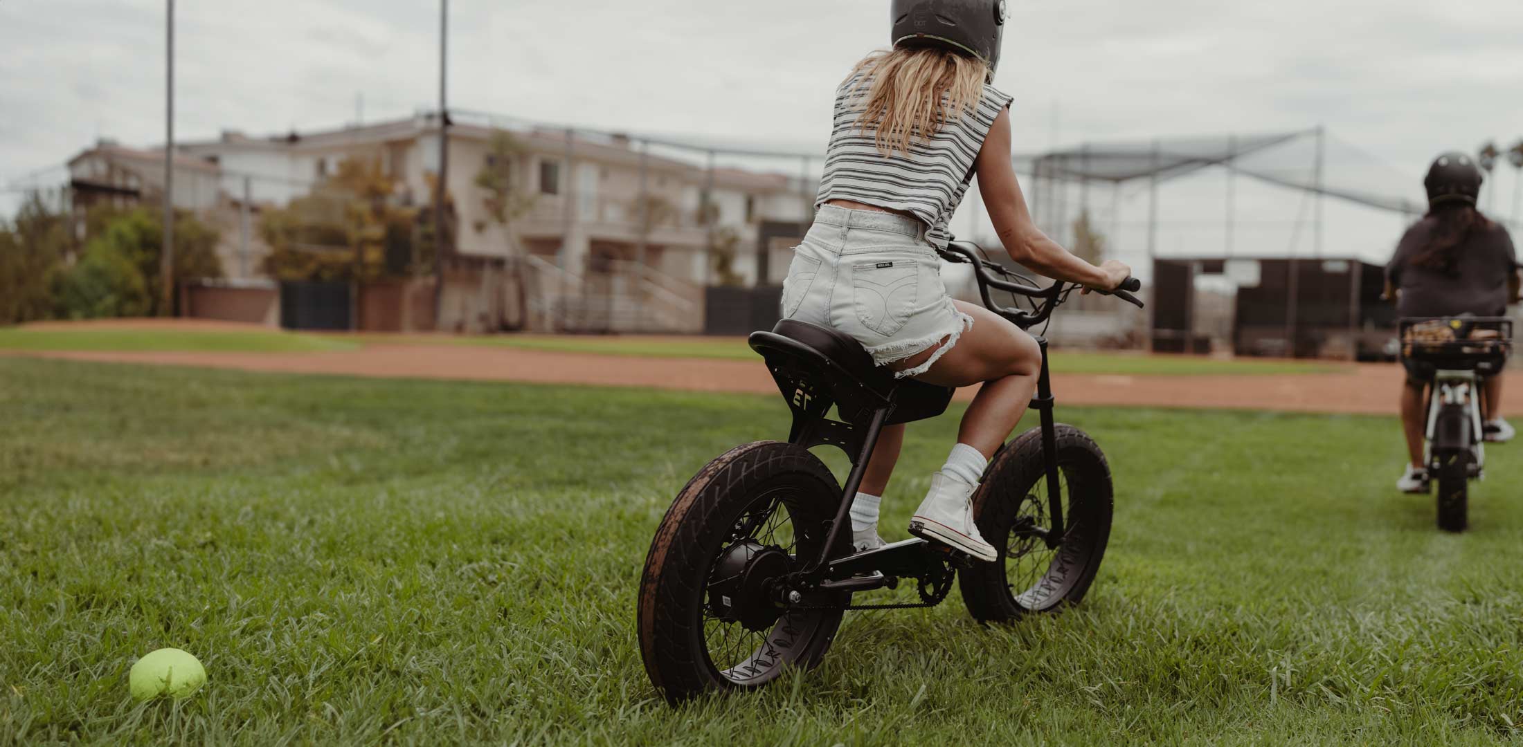 Lifestyle image of students riding their Super73s on the baseball field