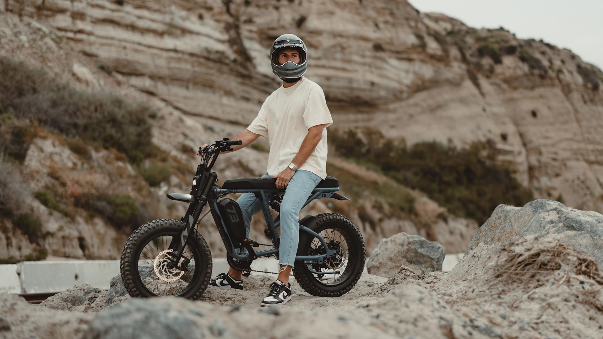 Lifestyle image of post grad riding his SUPER73 R Adventure on an adventure.