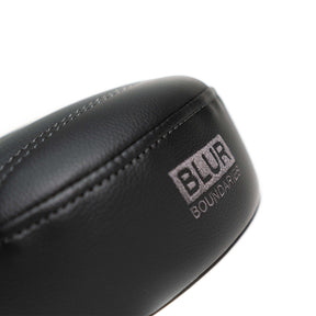 Back of the black Caterpillar seat with embroidered Blur Boundaries logo in grey