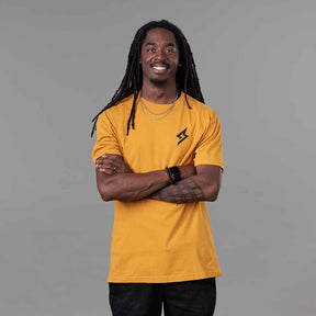 Front view of The Trailblazer Tee (Antique Gold) on male model