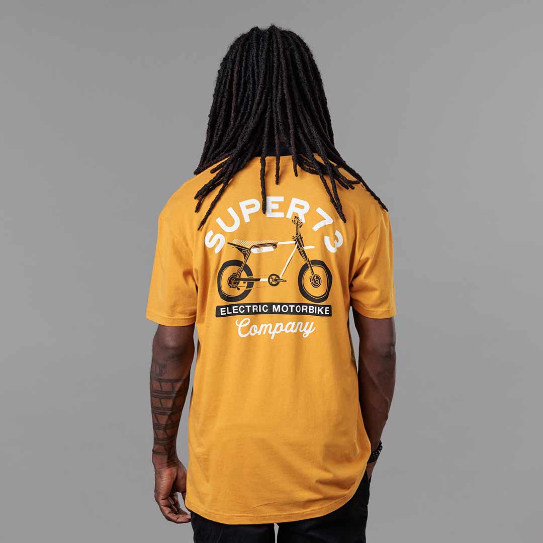 Back view of The Trailblazer Tee (Antique Gold) on male model