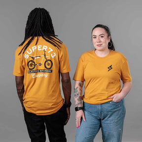Studio image of The Trailblazer Tee (Antique Gold) on both male and female models 