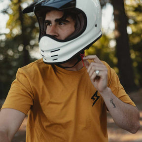 Front view of The Trailblazer Tee (Antique Gold) on male model