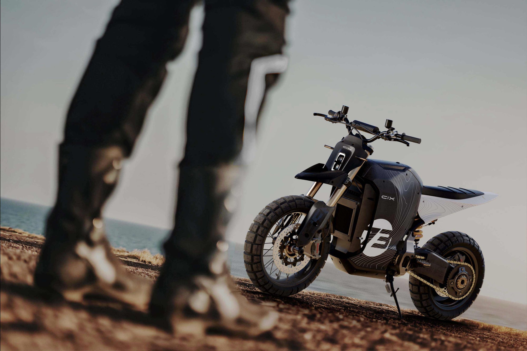 Lifestyle image of the El Jefe Scrambler Dual Sport C1X bike with a rider in the foreground