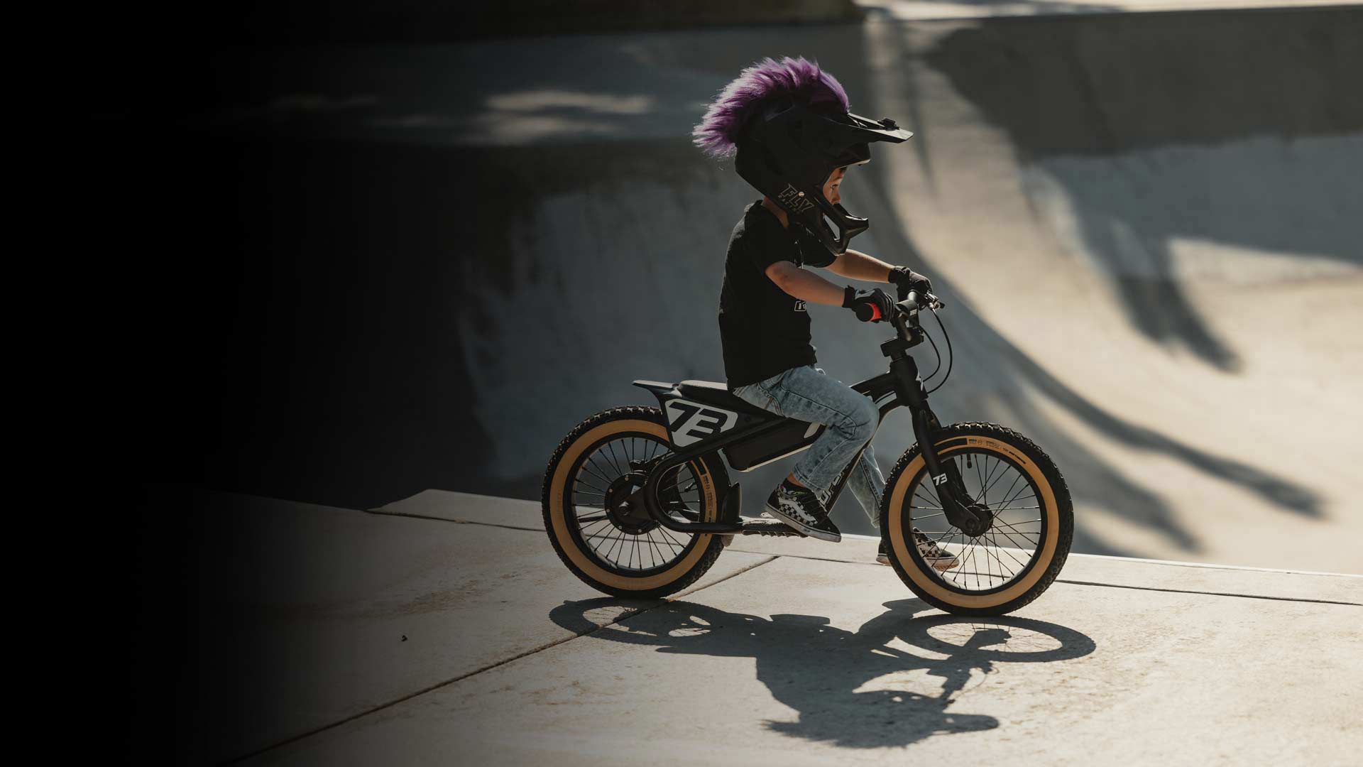Lifestyle image of a kid wearing a helmet and riding a K1D ebike.