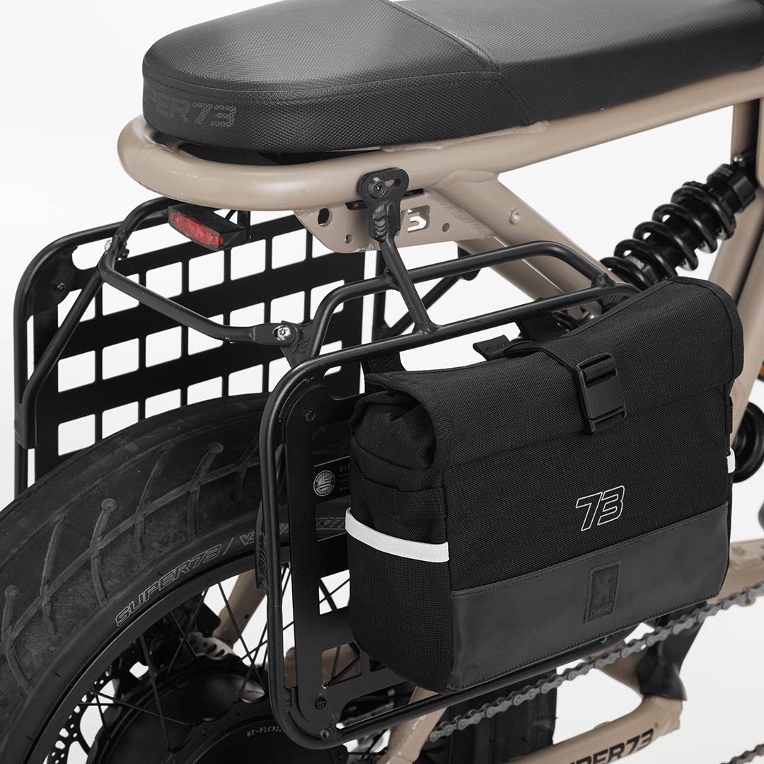 Side profile product image of the R Series Side Rack on bike with Chrome bag attached.