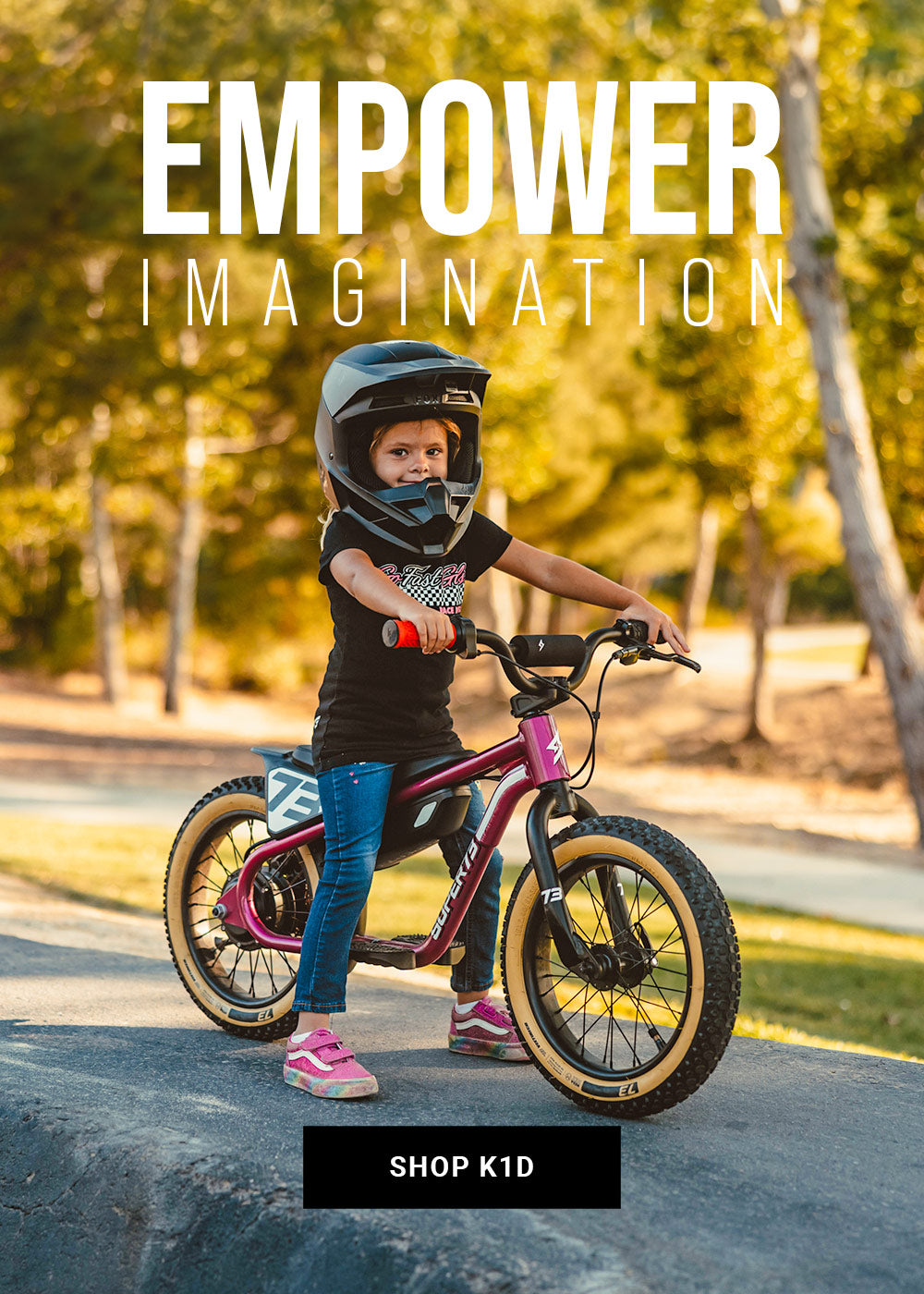 Lifestyle image of a young girl in a helmet riding a SUPER73-K1D ebike in Prickly Pink