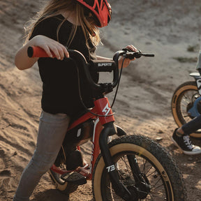 lifestyle image of a kid on a K1D showcasing the K1D Big Trouble Handlebar on K1D
