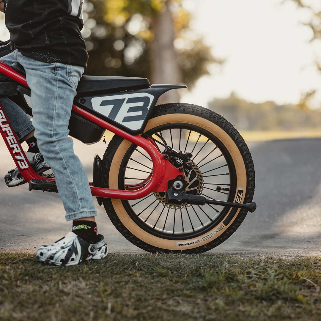 Lifestyle image of a kid riding his K1D featuring the K1D Mega Hex Tire 16in. x 2.4in.