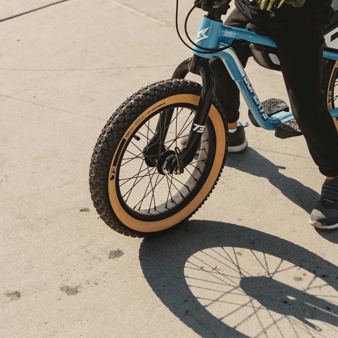 Lifestyle image of a kid riding his K1D featuring the K1D Mega Hex Tire 16in. x 2.4in.