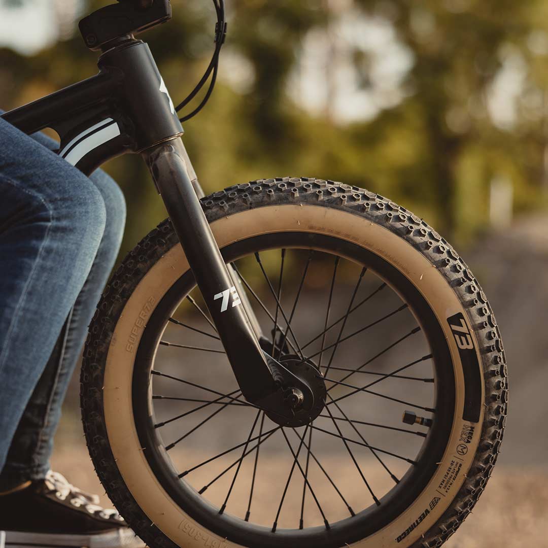 Lifestyle image of a kid riding his K1D featuring the K1D Mega Hex Tire 16in. x 2.4in.