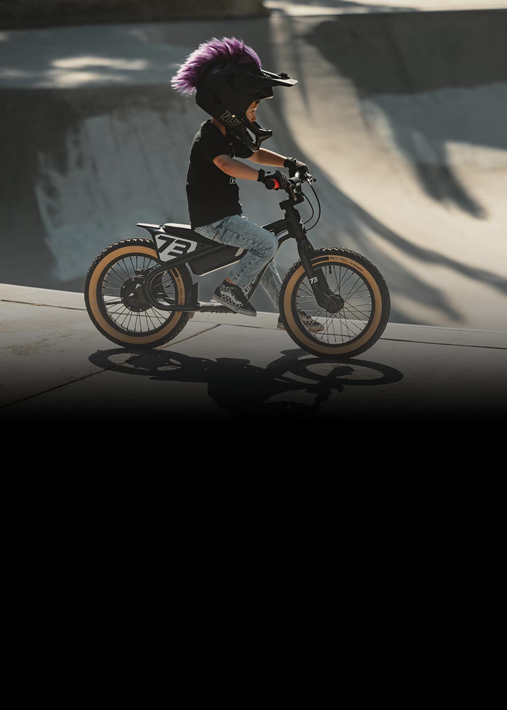 Lifestyle image of a kid wearing a helmet and riding a K1D ebike.