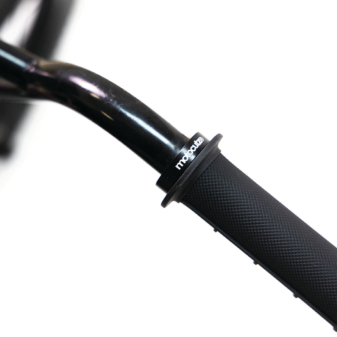 Alternate close-up of the MotoCutz Mid Flange Bolt-On Grips in Black on a handlebar.