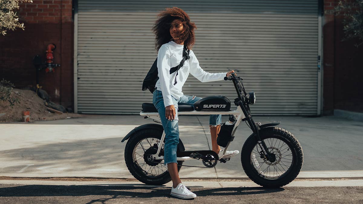 A young woman sitting on a SUPER73 S Series ebike