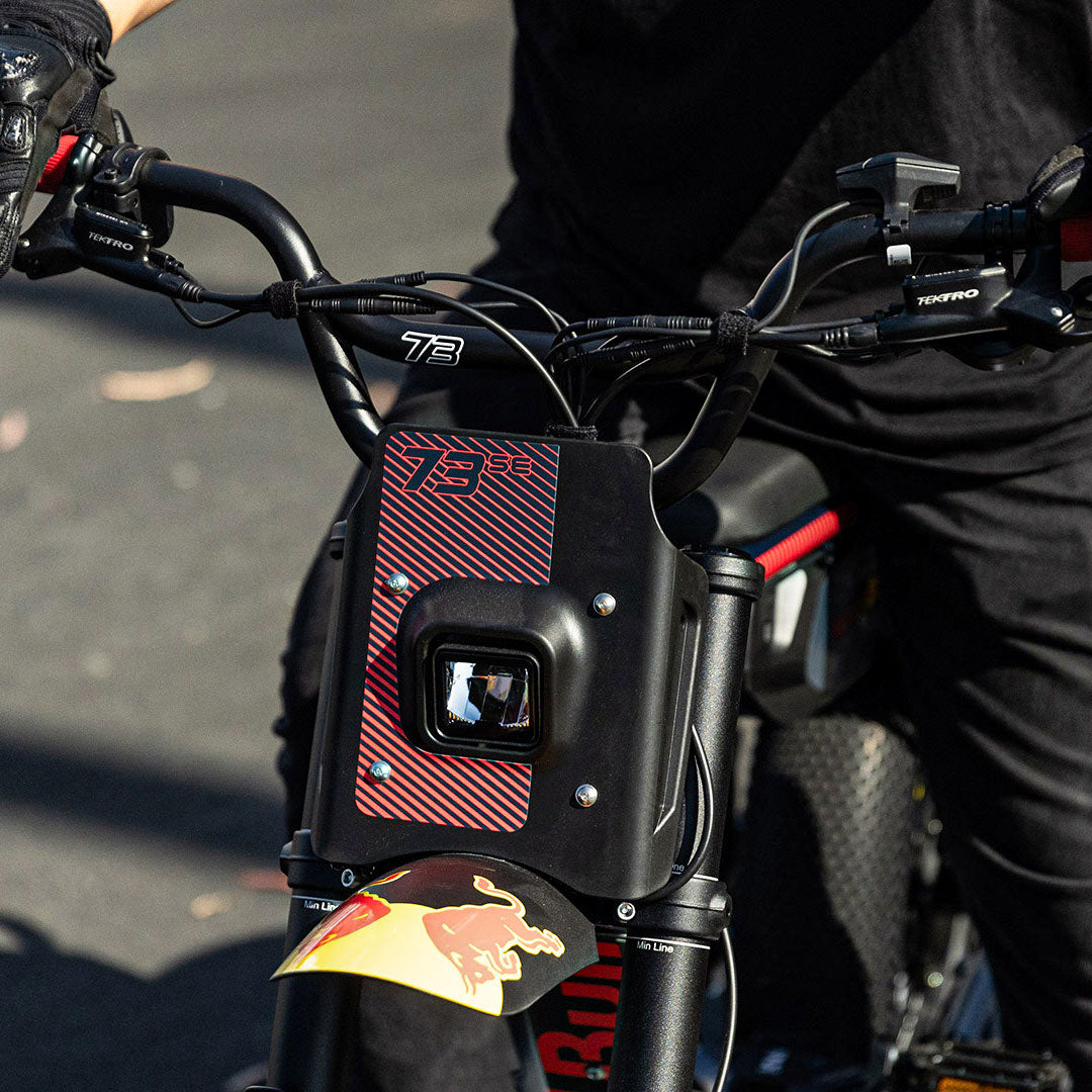 Lifestyle photo showing the handlebars and headlight on the Oracle Red Bull Racing x SUPER73 Z Adventure Series ebike