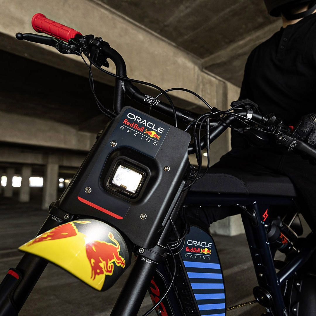 Lifestyle image of the custom branded decals and headlight on the Oracle Red Bull Racing x SUPER73 R Adventure Series ebike