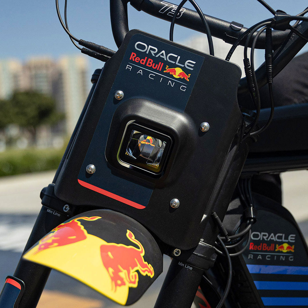 Lifestyle image showing the custom branded decals and headlight on the Oracle Red Bull Racing x SUPER73 R Adventure Series ebike