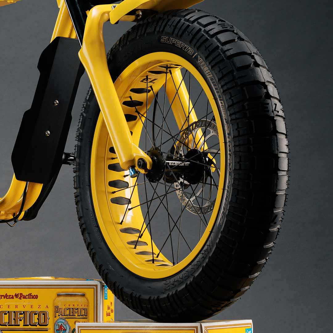 Close-up photo of the custom Pacifico x SUPER73-S2 bike yellow rims.