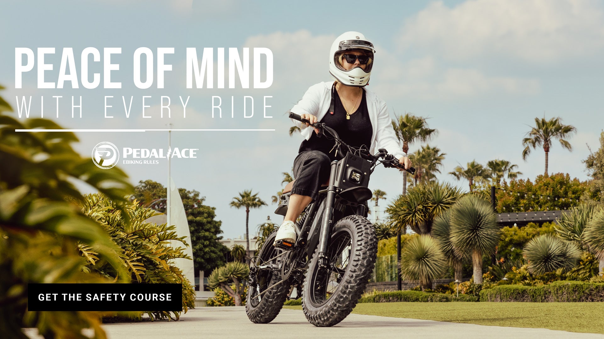 Lifestyle image of a young woman in a helmet riding a SUPER73 ebike down a bike path