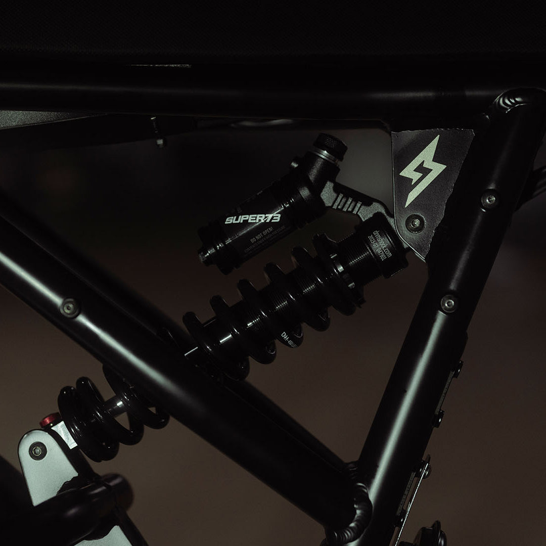 Close-up image of the rear shock on the SUPER73-R Adventure SE ebike in Bandit