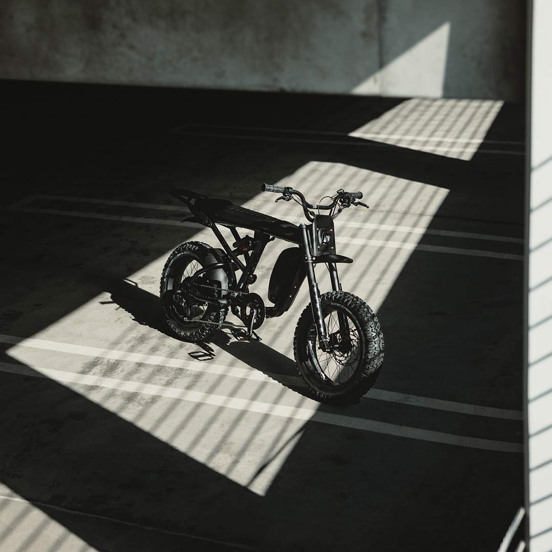 Image of a SUPER73-R Blackout SE bike in a parking garage.