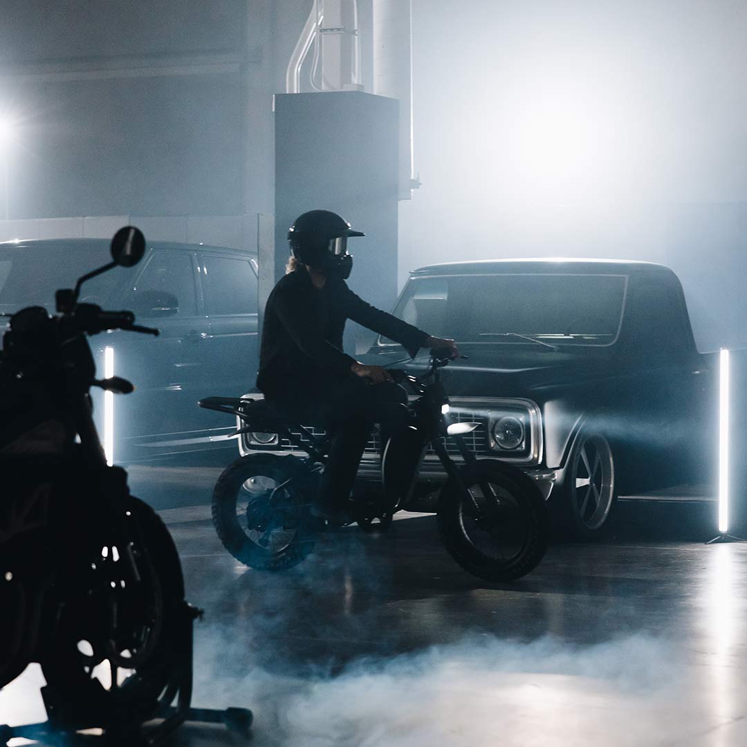 Image of a rider on a SUPER73-R Blackout SE bike in a warehouse.