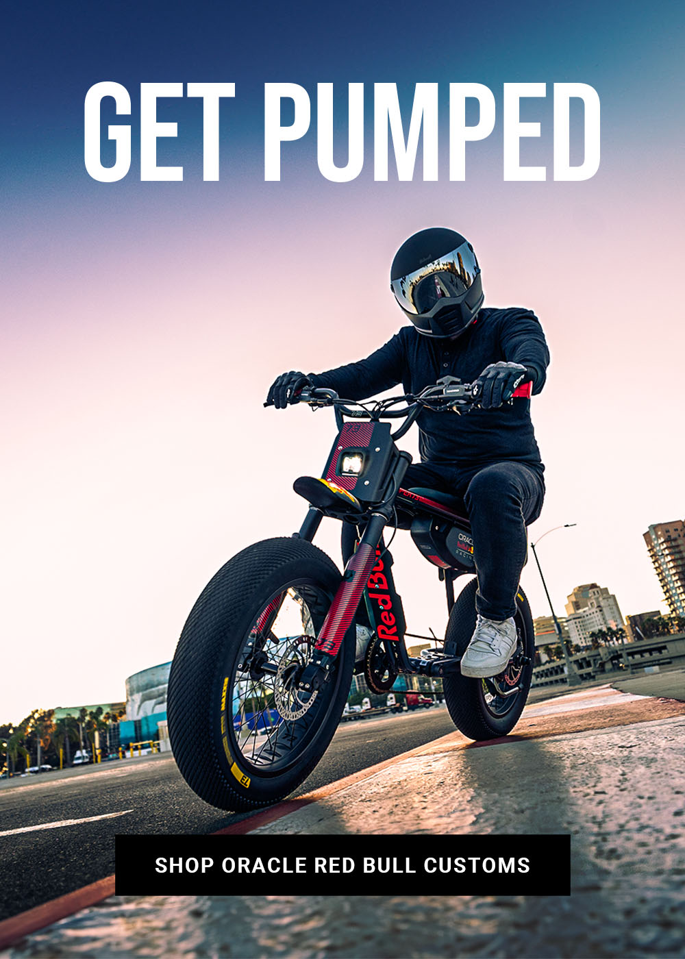 Lifestyle image of a man in a helmet riding the Oracle Red Bull Racing Z Adventure Series ebike