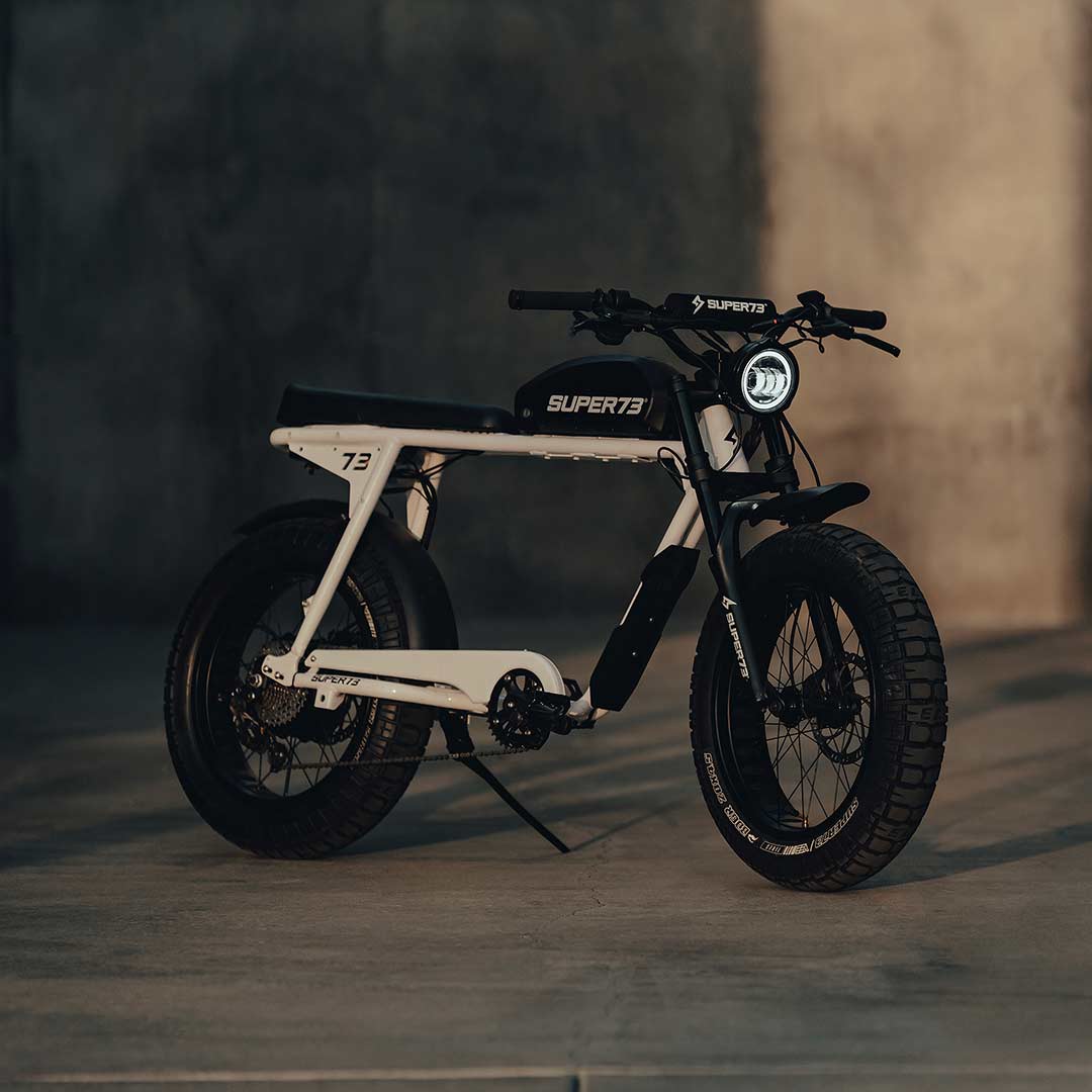 SUPER73 S2 ebike sitting on it's kickstand in a handball court at golden hour