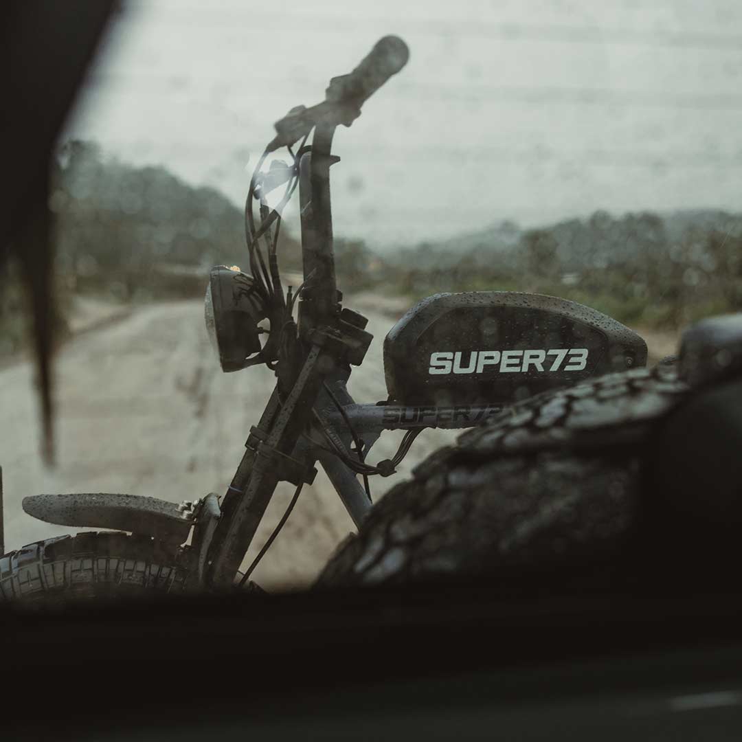 SUPER73 S2 ebike seen through the back window of a Bronco on a stormy day