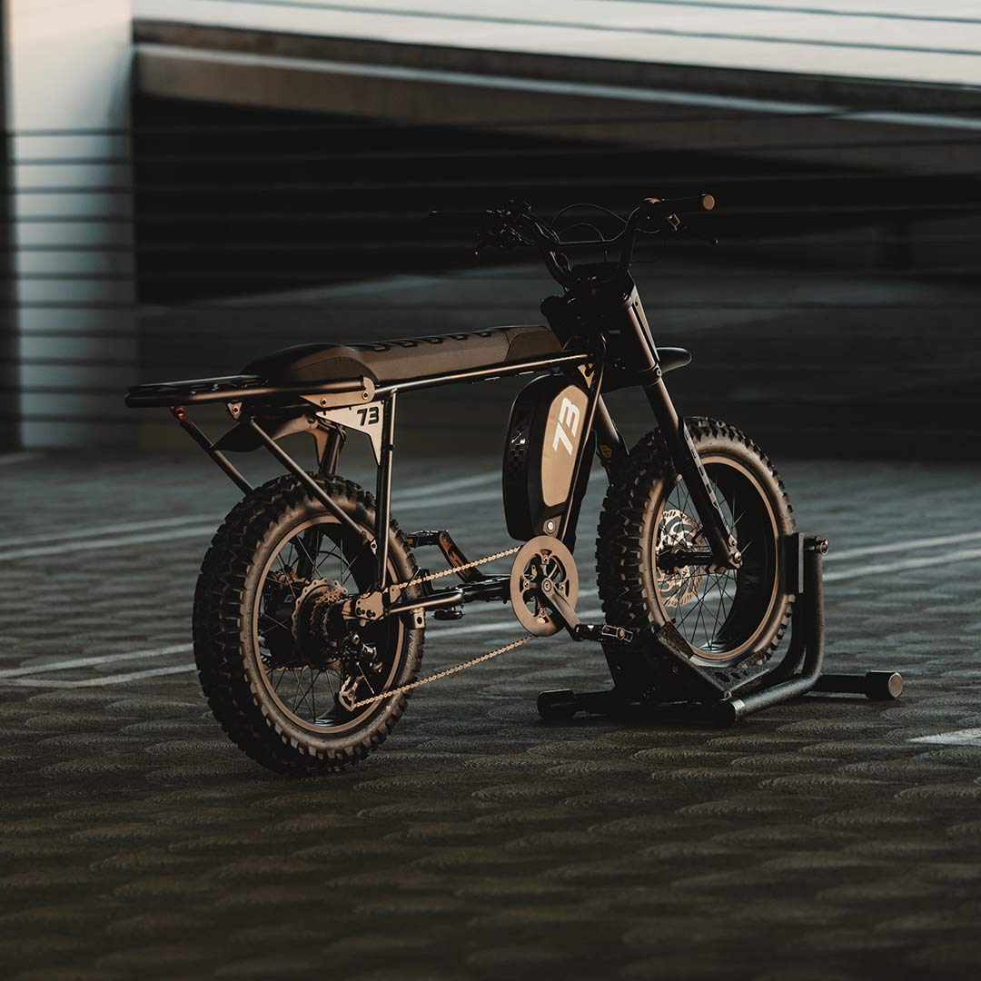 Rear image of a SUPER73-S Blackout SE bike in a parking garage.