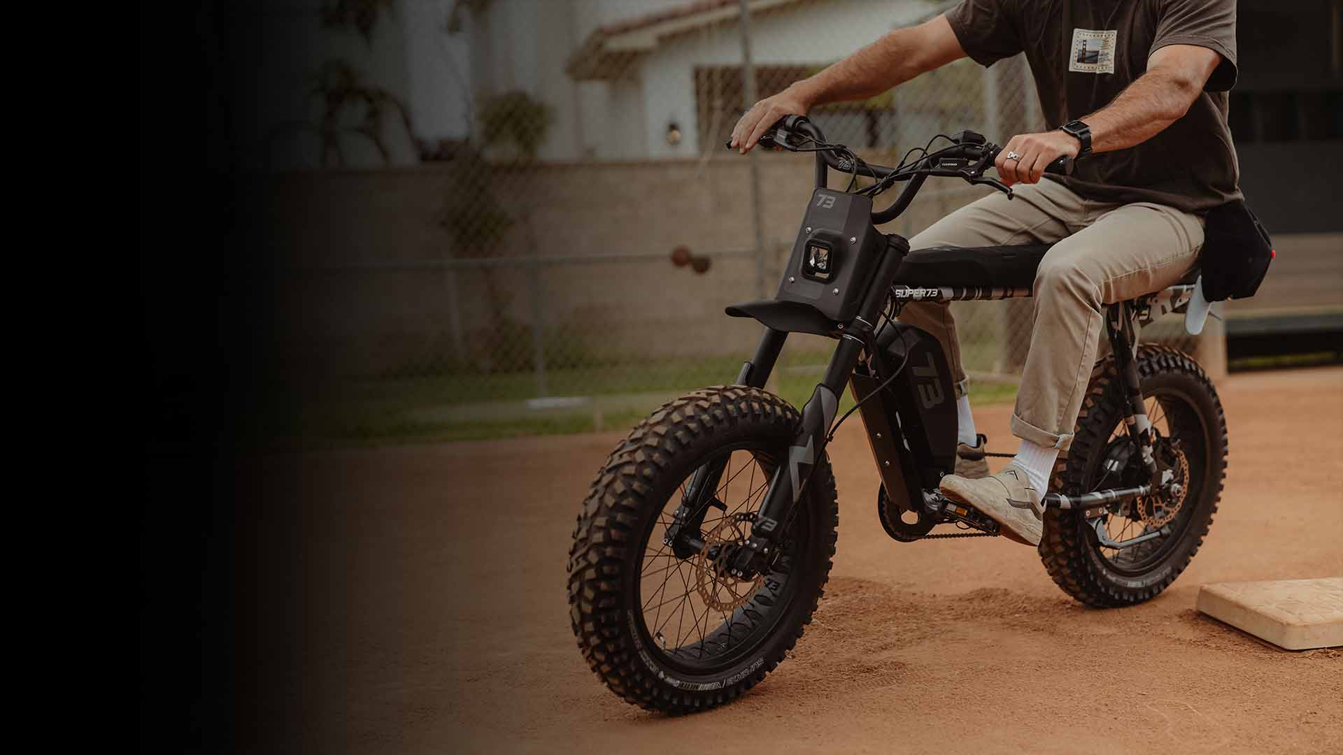 Man riding a SUPER73-R Adventure Series bike on dirt.