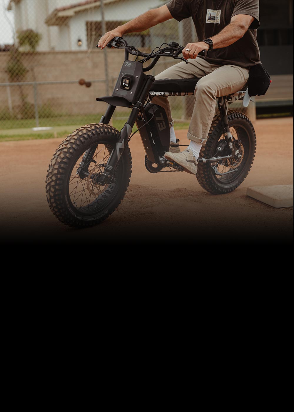 Man riding a SUPER73-R Adventure Series bike on dirt.