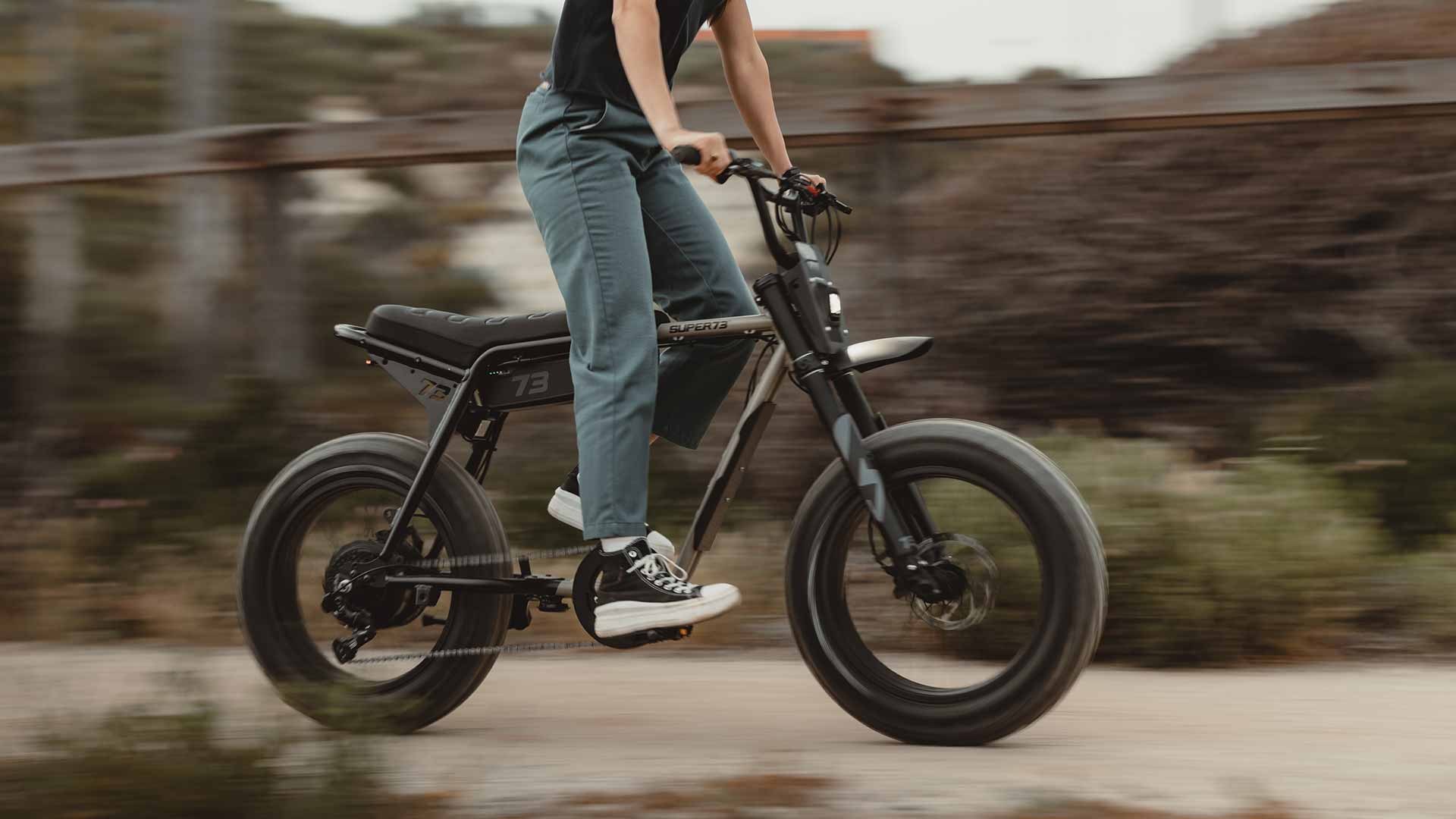 Rider on a Super73 Z Adventure ebike standing on the pedals hitting the throttle