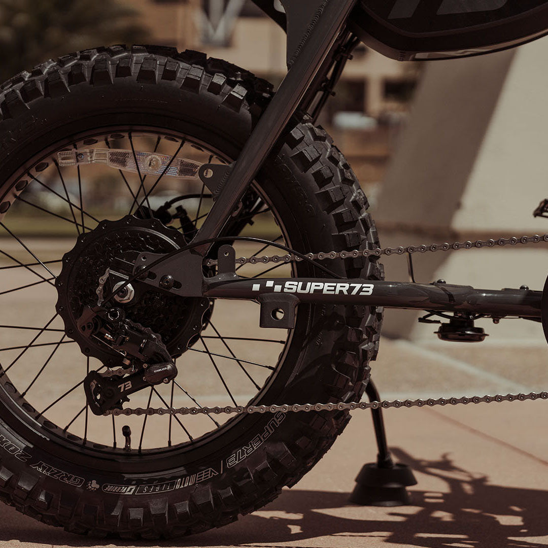 Close-up image of the rear tire and branded decals on the SUPER73-Z Adventure SE ebike in Bandit