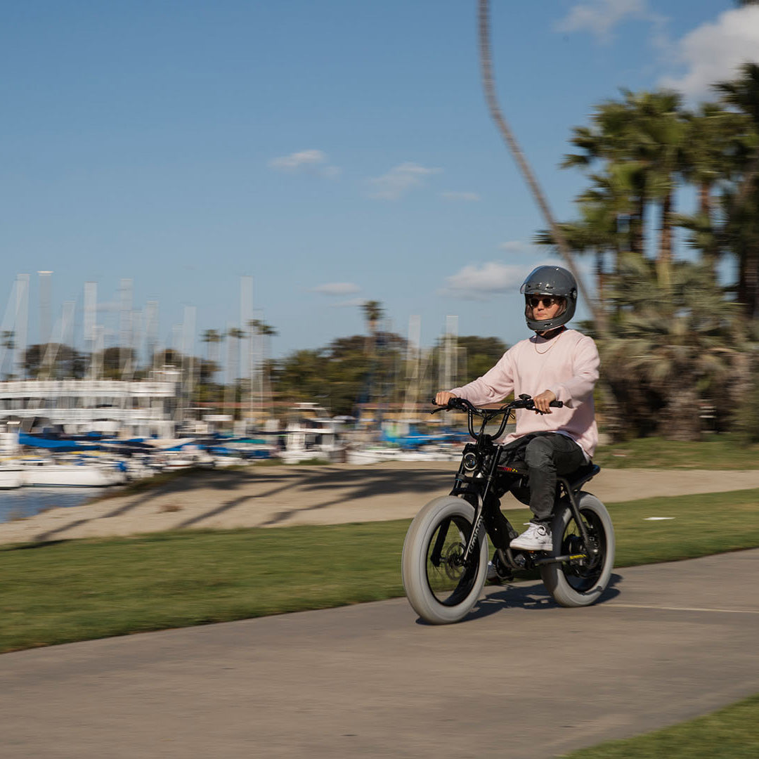 Lifestyle image of a man in a helmet riding a SUPER73-Z Miami LE ebike in Speedway