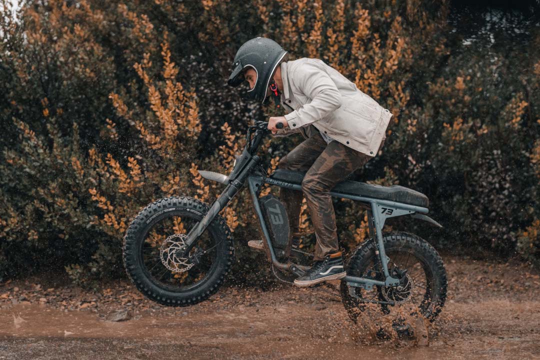 Rider skidding through the mud on a Super73 Adventure Series bike