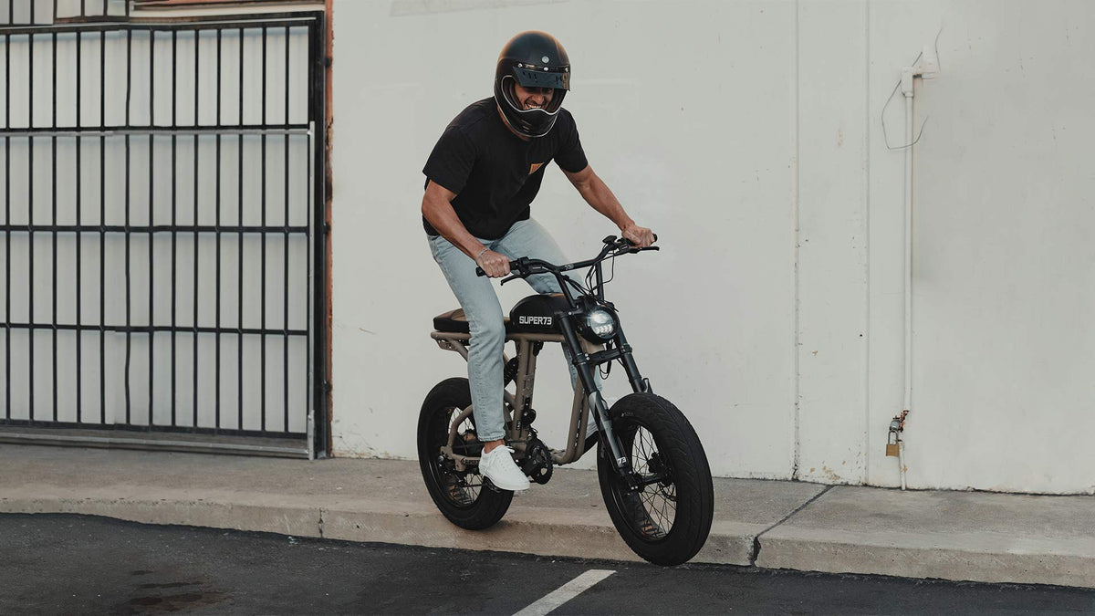Rider on Super73 ebike going extreme off of pure concrete curb