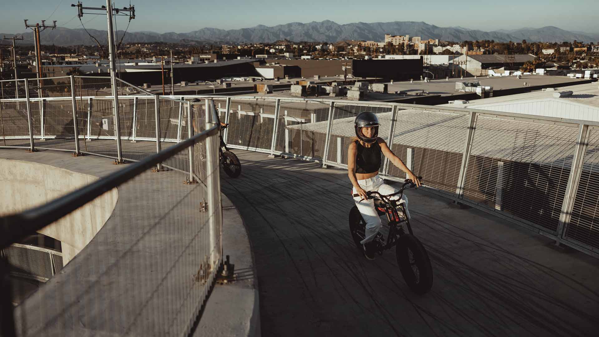 Rider ascending a bridge ramp in a city environment