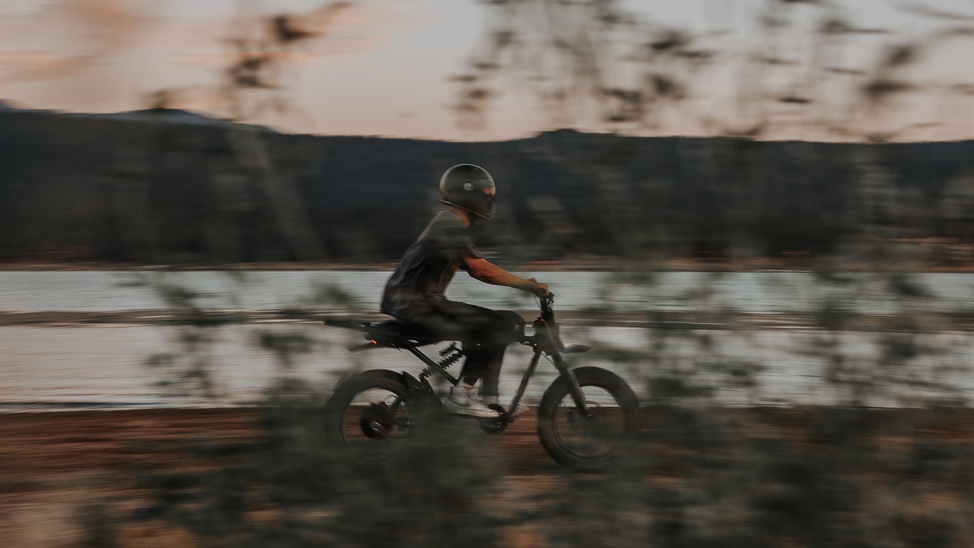 Rider Racing along body of water on Super73 ebike