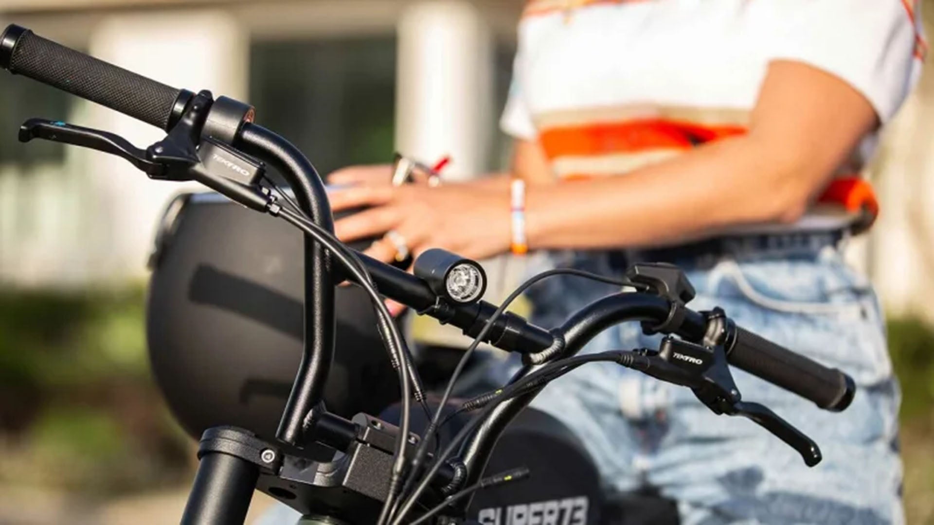 Closeup of handlebars with mounted light and throttle controls